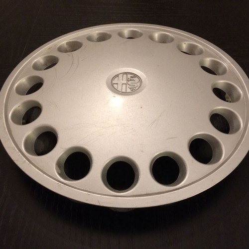 Alfa Romeo 75 hubcap used with scratches and marks