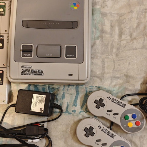 Super Nintendo Entertainment System (SNES) console with 4 games