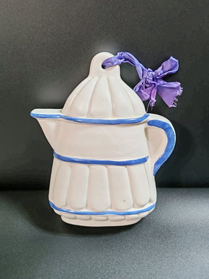 Glazed ceramic jelly mold new with relief and purple ribbon