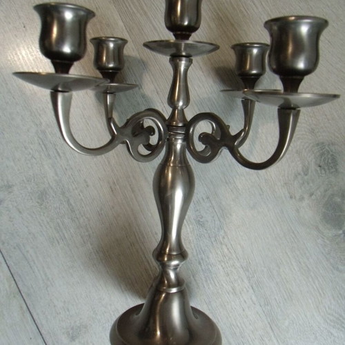 Old metal candlestick with five holders used