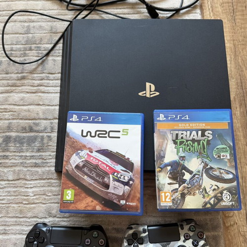 PlayStation 4 Pro 1TB console used with 2 original controllers and games