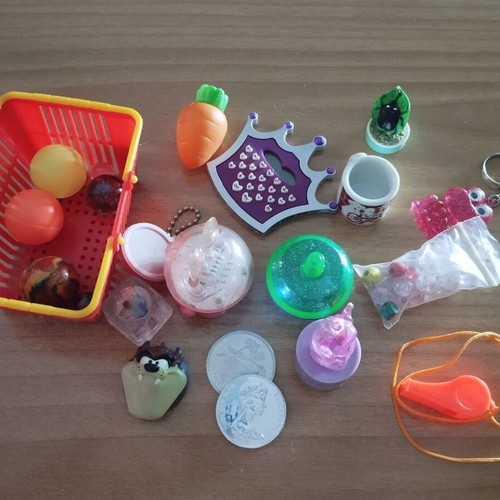 Various toys like new, including keychains, balls, marbles, beads, whistle