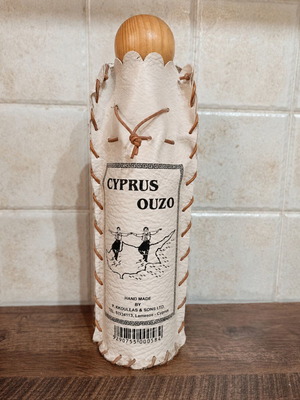 Decorative Cyprus Ouzo bottle cover with wooden lid like new
