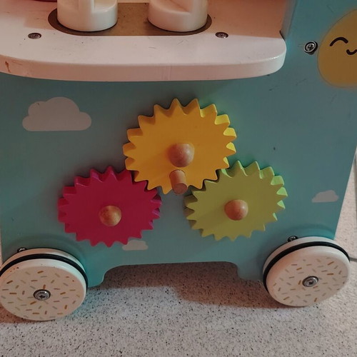 Wooden play kitchen with oven used, with pots and spoons