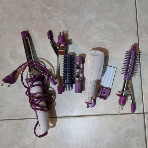 Hair styling iron with multiple attachments used