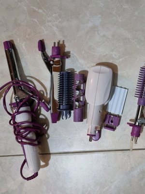 Hair styling iron with multiple attachments used