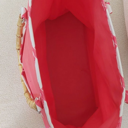 Clinique Limited Edition handbag, coral pink with white geometric pattern and bamboo handles