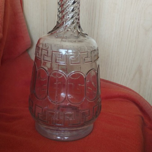 Glass wine carafe used with meander design