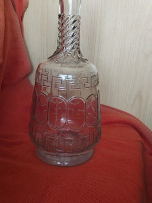 Glass wine carafe used with meander design