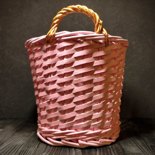 Decorative pink rattan basket with gold handles, handmade