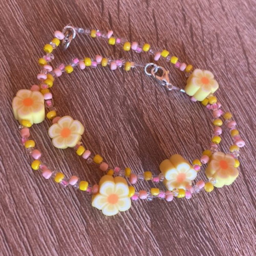 Friendship bracelets set with yellow and pink flowers made to order
