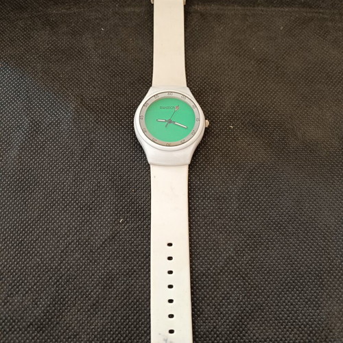 Swatch watch used with white silicone strap and green dial