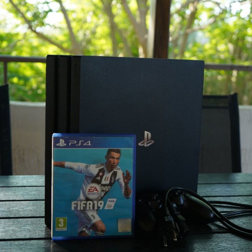 PS4 Pro 1TB console with FIFA 19 game, power cable and controller