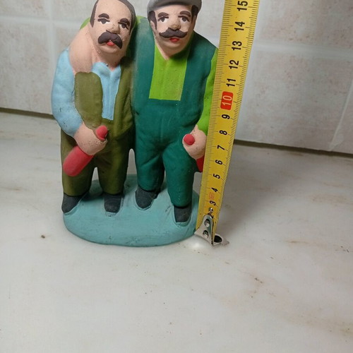 Ceramic figure of two men with traditional costumes like new