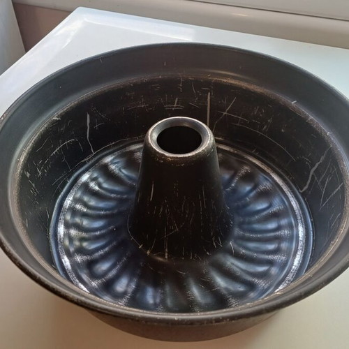 Large cake pan used with visible signs of wear