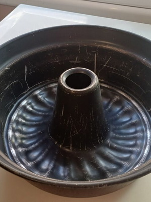 Large cake pan used with visible signs of wear
