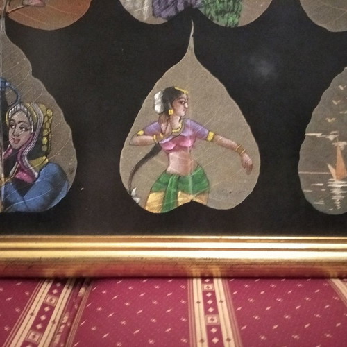 Painting with African figures hand-painted on dried leaves with gold frame and glass