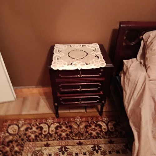 Double bed with two nightstands, mirror and unused mattress