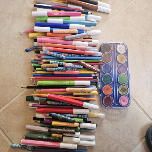 Makeup bag with markers, colored pencils, crayons, and watercolors used