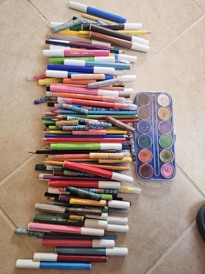Makeup bag with markers, colored pencils, crayons, and watercolors used