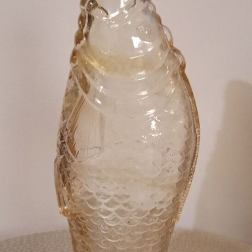 Glass bottle in fish shape used