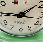  Κουρδιστό ρολόι στρογγυλό σε βάση Εμαγιέ Golden Cock με δείκτη ημέρας Εποχής 1960