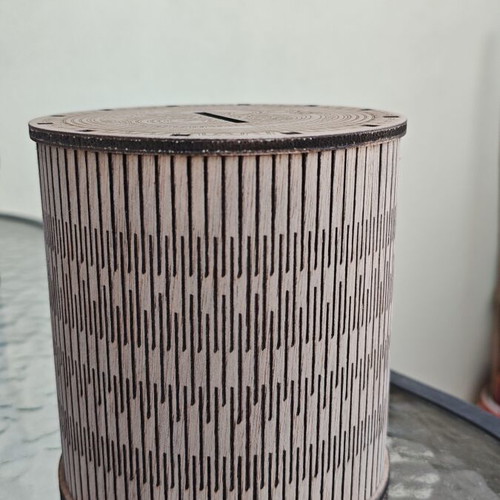 Handmade wooden laser-cut piggy bank with mechanical design