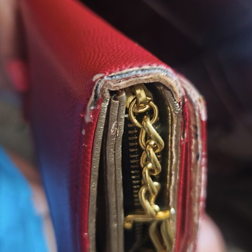 Juicy Couture red wallet used with side wear on gold details