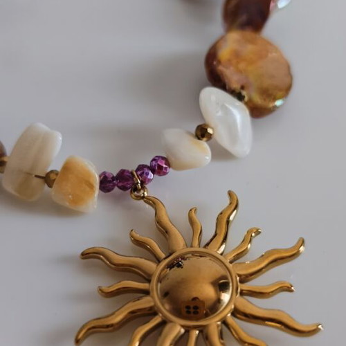 Necklace with mother of pearl and gold steel sun pendant