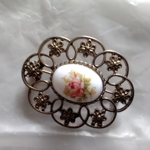 Metal brooch with porcelain detail used