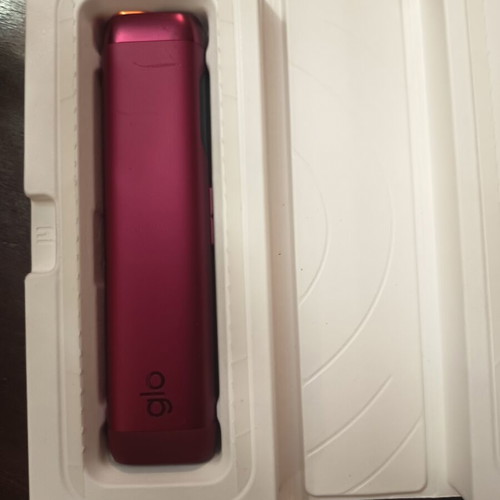 Glo electronic device with charging cable and cleaning brush