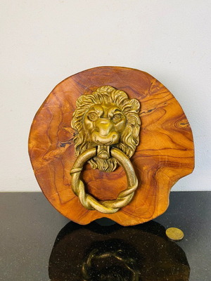 Bronze door knocker used with lion head and wooden base
