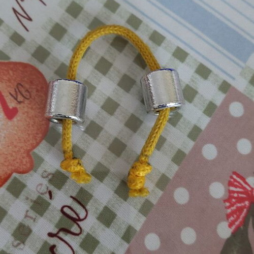 Metal worry beads used with yellow cord
