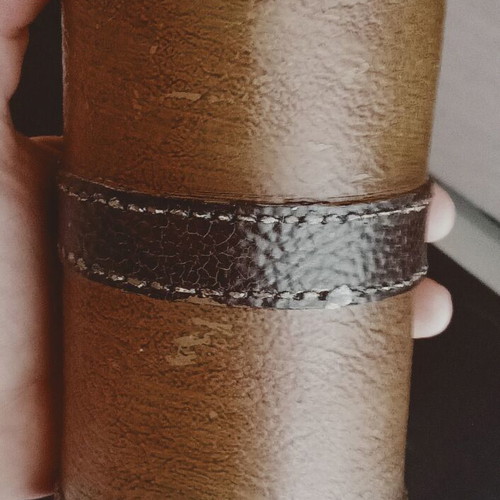 Set of two decorative candles with belt motif, brown and olive