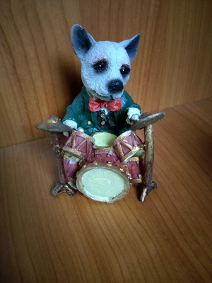 Decorative dog figure with drums like new
