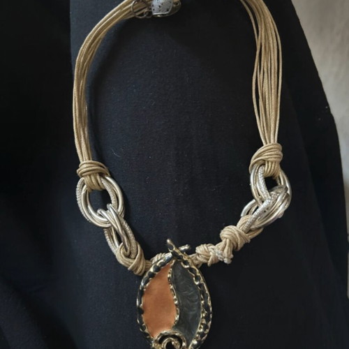 Statement necklace with multistrand cord, metal rings and pendant