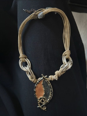 Statement necklace with multistrand cord, metal rings and pendant