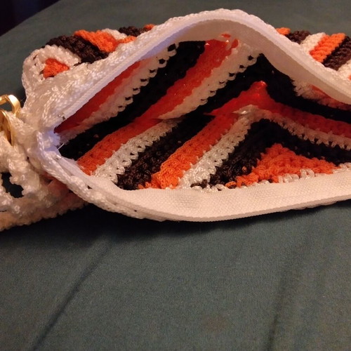 Knitted wrist bag, white and orange