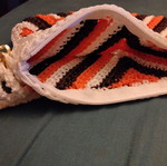 Knitted wrist bag, white and orange