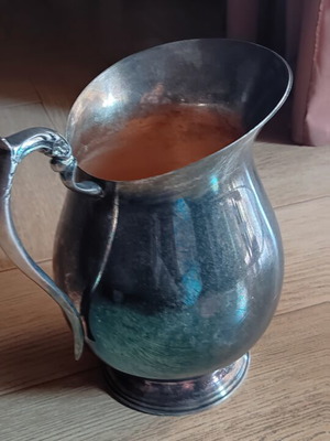 Vintage silver pitcher used with blue and gold accents