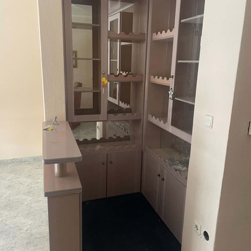 Mini bar like new with mirrors, cabinets, and carpeted floor