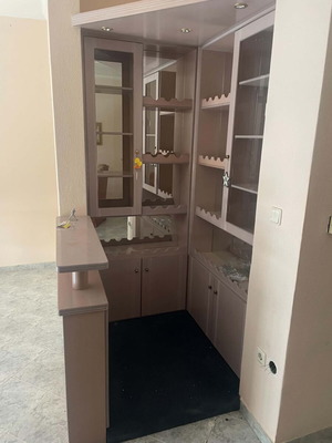 Mini bar like new with mirrors, cabinets, and carpeted floor