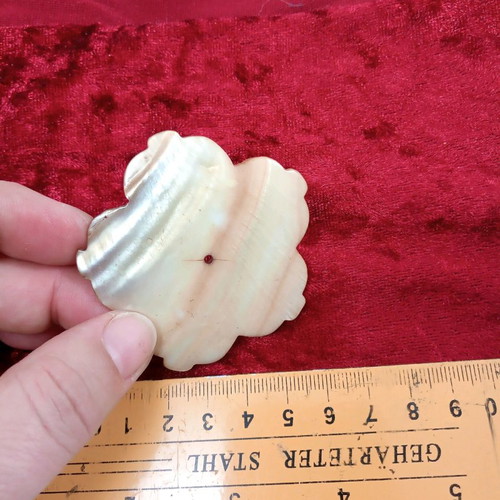 Carved coffee-yellow mother-of-pearl element with hole hibiscus shape