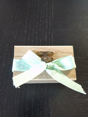 Box like new with blue ribbon