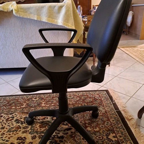 Office chair used with black leatherette upholstery
