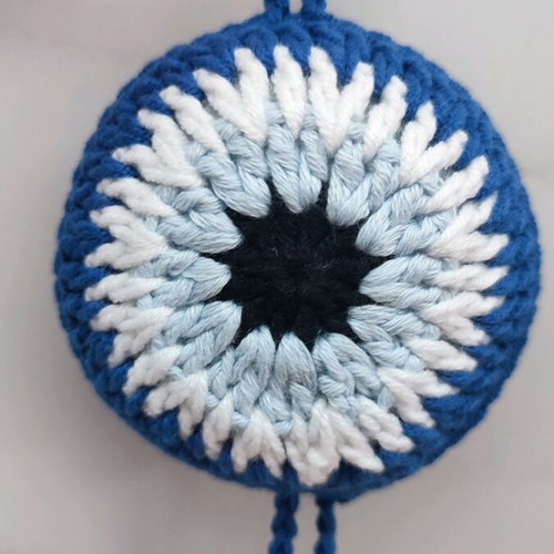 Handmade knitted eye in dark blue color