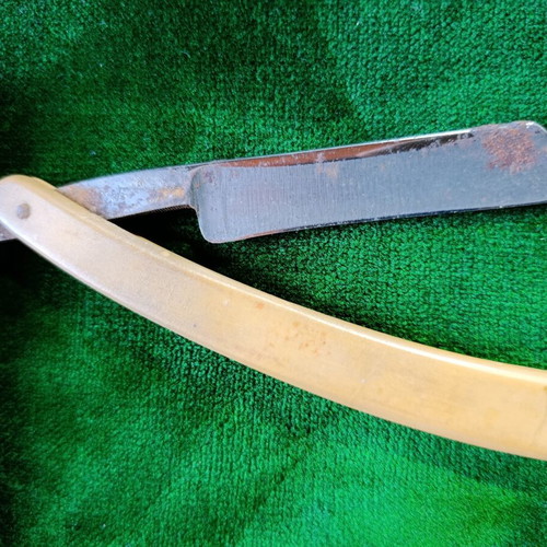 Vintage straight razors with leather strop and wooden handle