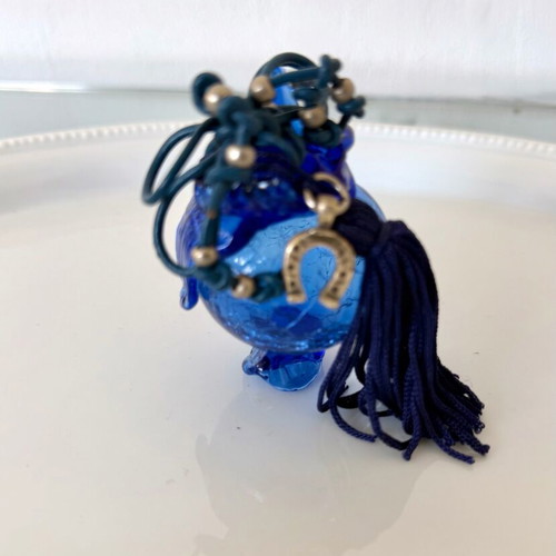 Handmade glass lucky charm in blue shades with horseshoe and silk tassel