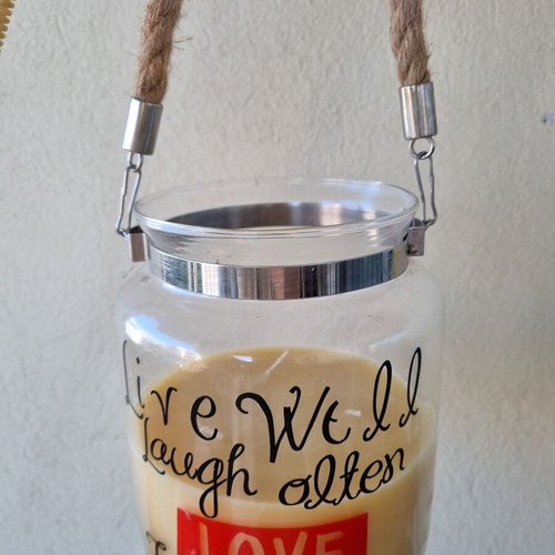 Aromatic candle in glass jar with quote