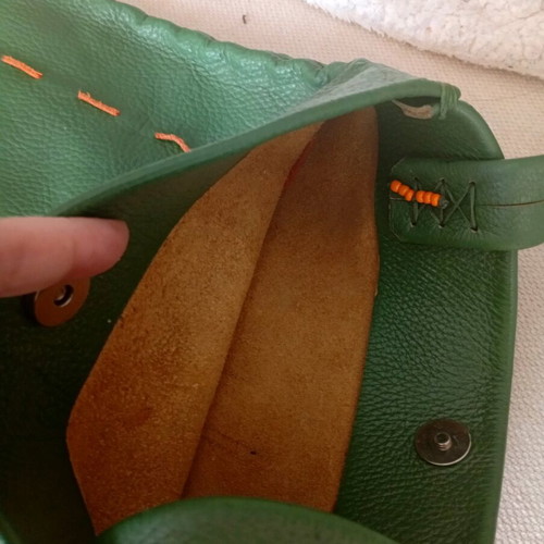 Handmade leather shoulder bag used in deep green boho style